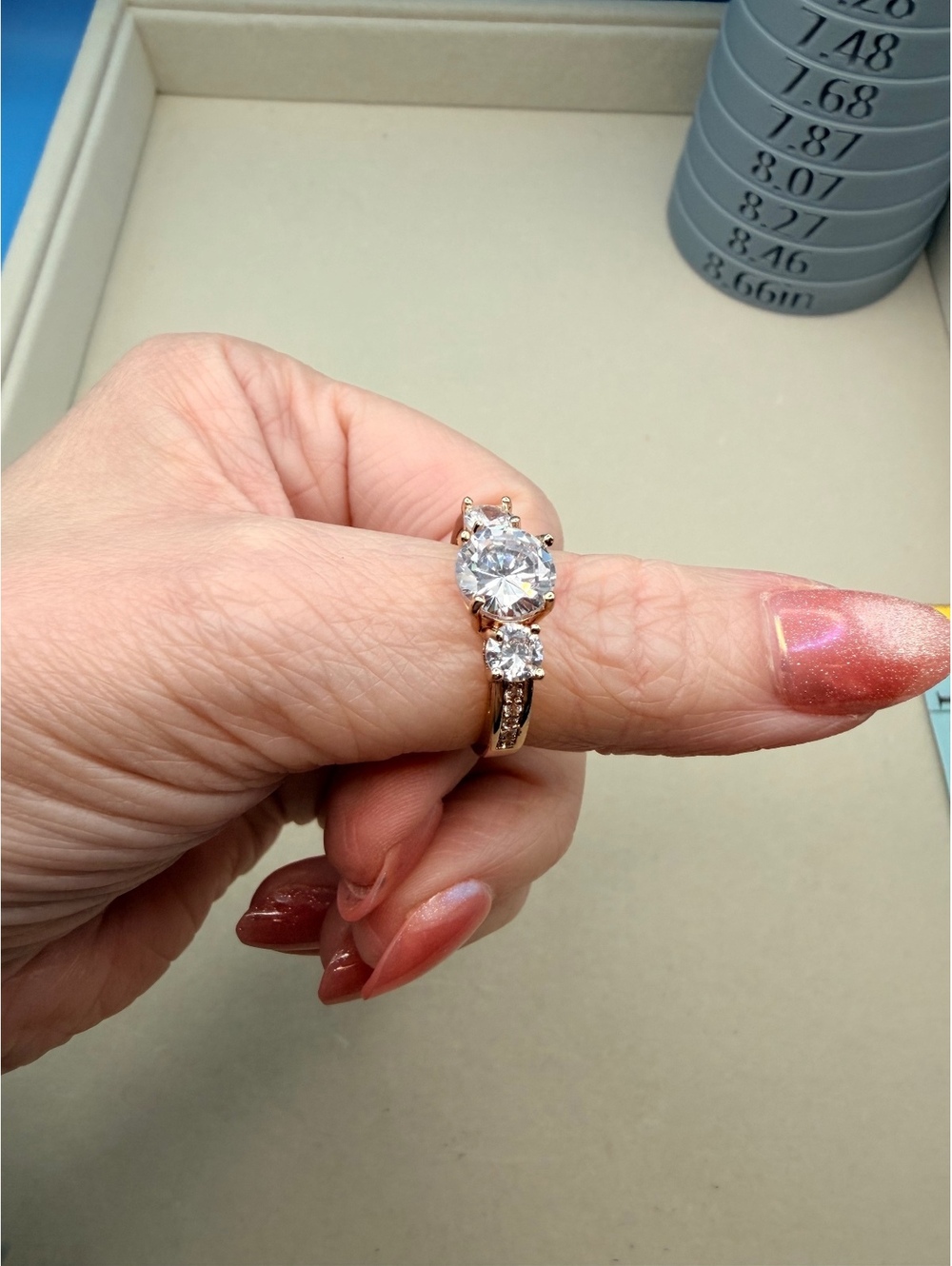 Gold tone three stone clear ring